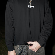 Model wearing black streetwear long sleeve front side KILOS clothing 