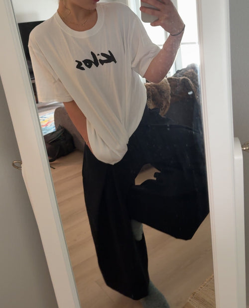 Person taking a selfie wearing KILOS clothing